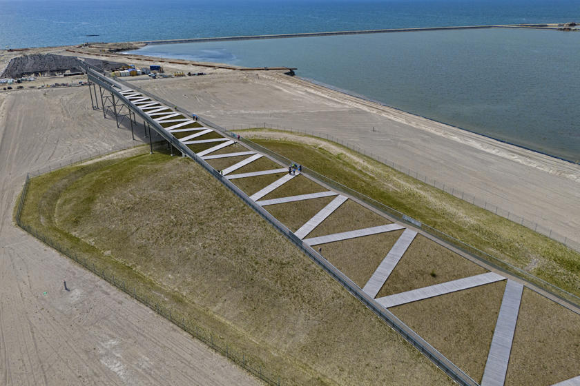 View from above of the Pilen viewing platform. A ramp that tapers to a point with a zigzag path leading upwards.